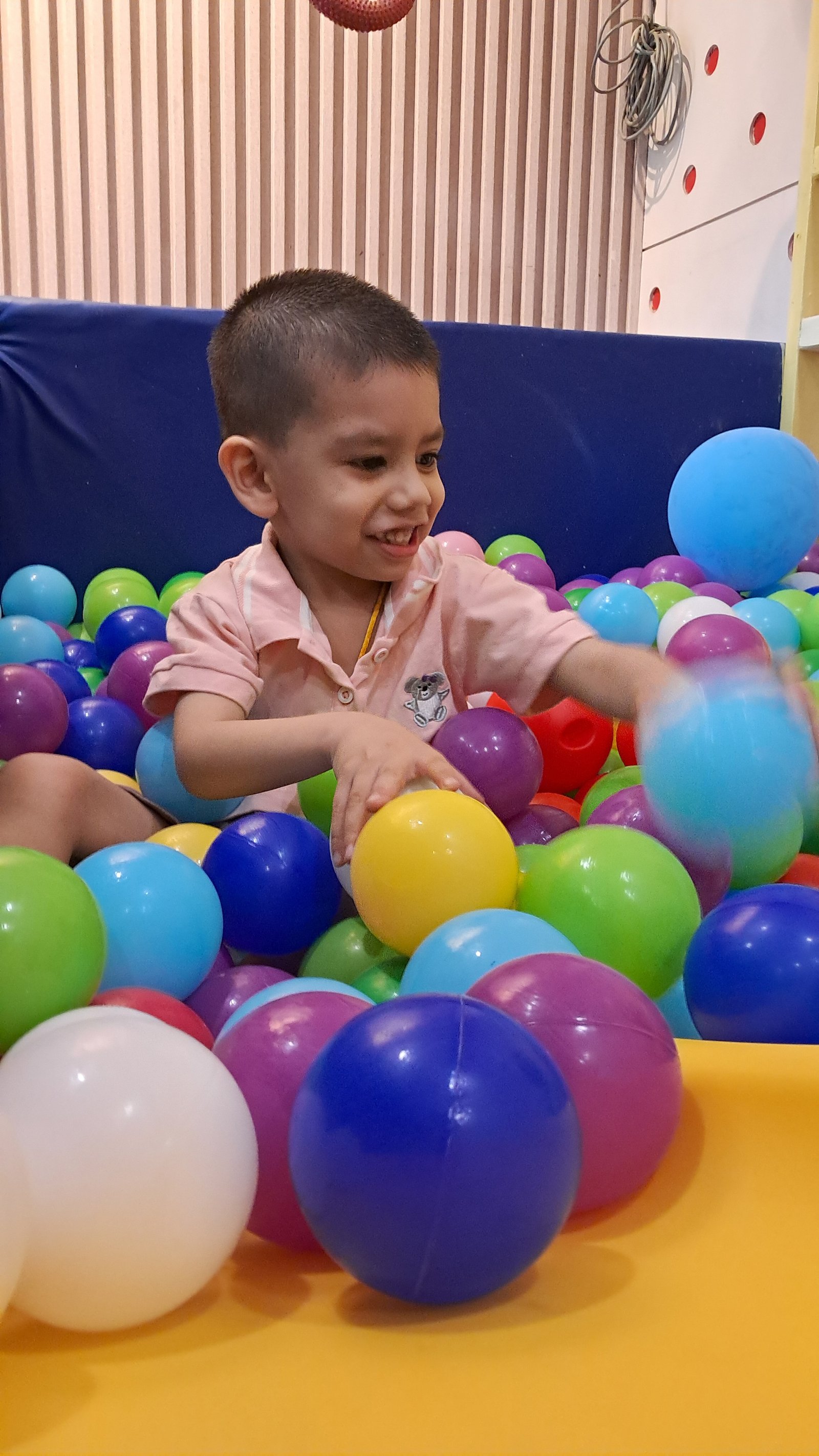 A child enjoying colourful ball play